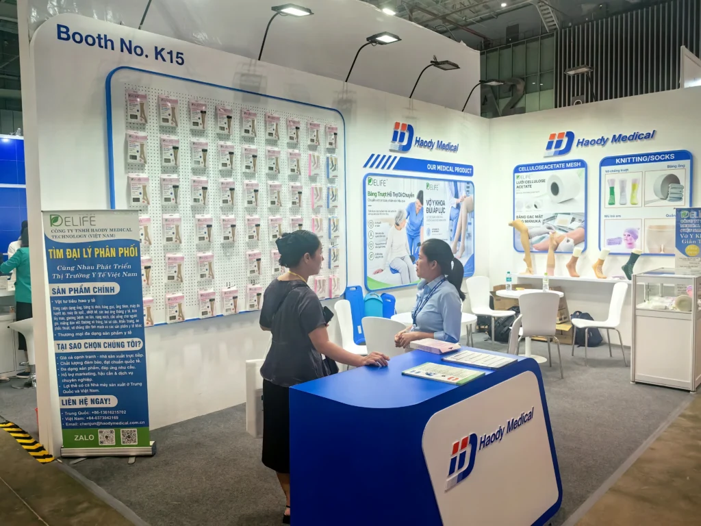 A Haody Medical team member speaking with a visitor at Booth K15 during PHARMEDI Vietnam 2026